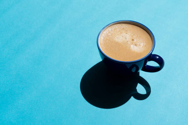 istock Cup of coffee on blue background 1400480982