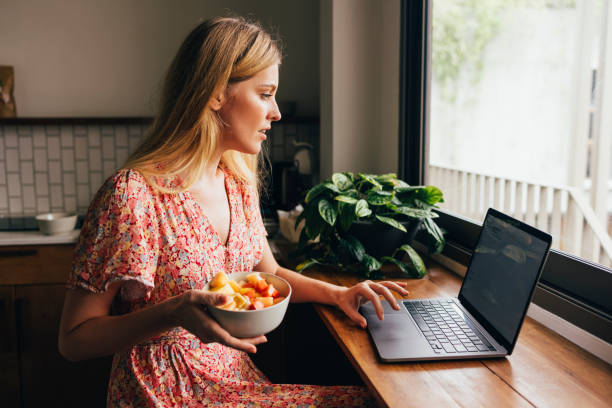 istock Woman Using Her Laptop In The Kitchen 1400481113