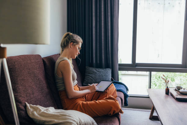 istock Woman Drawing On Her Tablet 1400481227