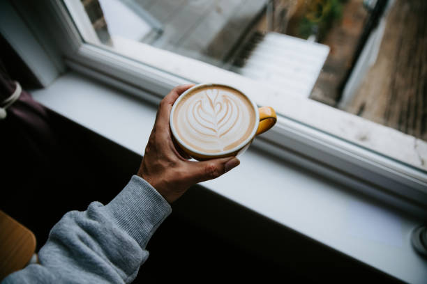 Man holding oat latte art POV stock photo
