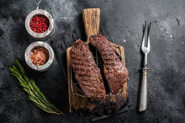 istock Grilled Machete skirt steak on grill. Black background. Top view 1400486733
