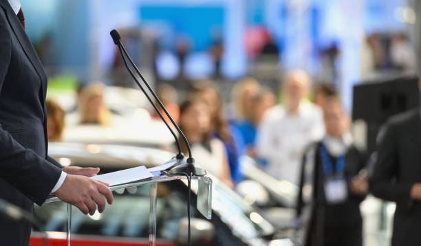 Politician speaking publicly from the lectern Politician speaking publicly from the lectern during political rally, Nikon Z7 press conference stock pictures, royalty-free photos & images