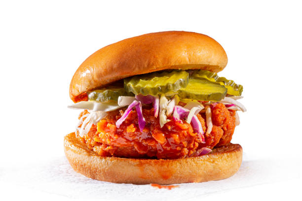 Spicy country fried chicken sandwich on a white background Spicy chicken sandwich with coleslaw and pickles on a brioche bun with copy space Chicken Burger stock pictures, royalty-free photos & images