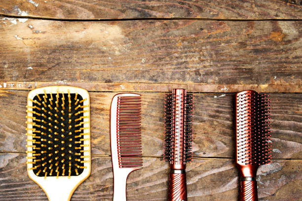istock Set of hairbrushes on wood table, Professional combs. Space for the text 1400489873