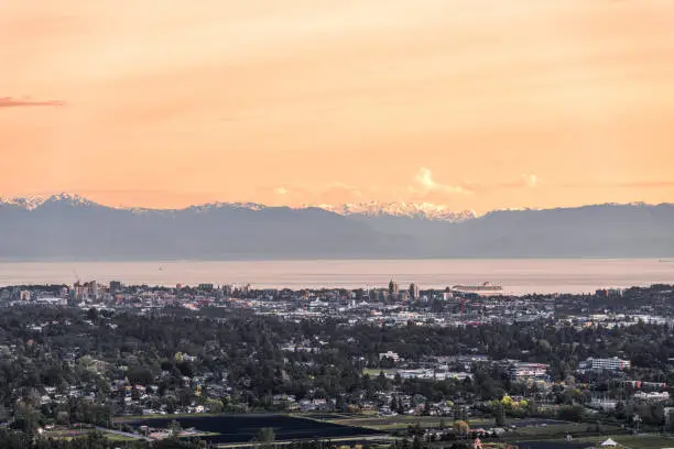 View of entire downtown Victoria at sunset with Olympic Mountains