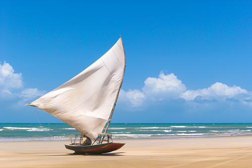 Traditional Sri Lankan fishing boat stranded on the beach in Rekawa