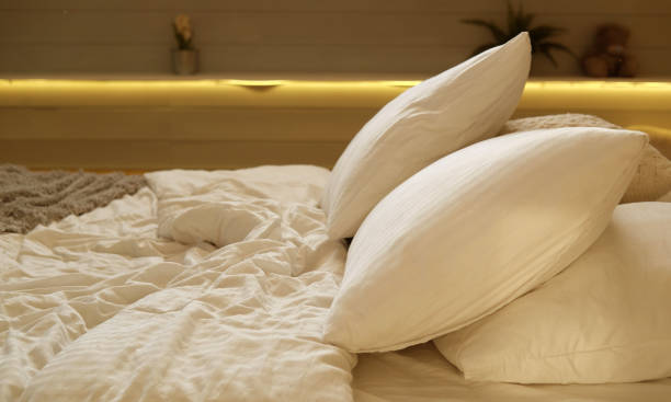 istock bed in the bedroom, white pillows and cozy linens 1400494080