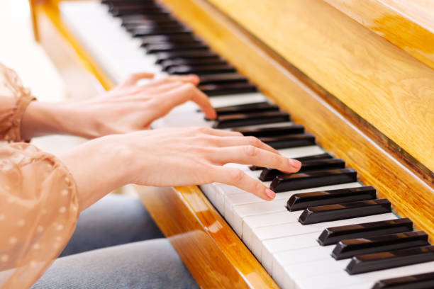istock Close up of hands playing the piano 1400494122