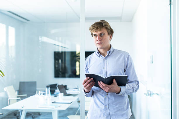 istock Young businessman with papers in the office 1400494495