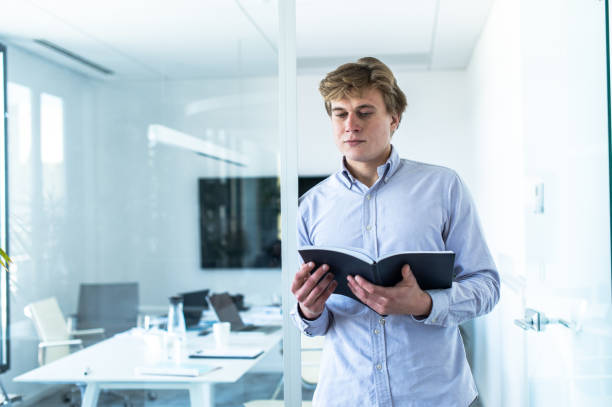 istock Young businessman with papers in the office 1400494499