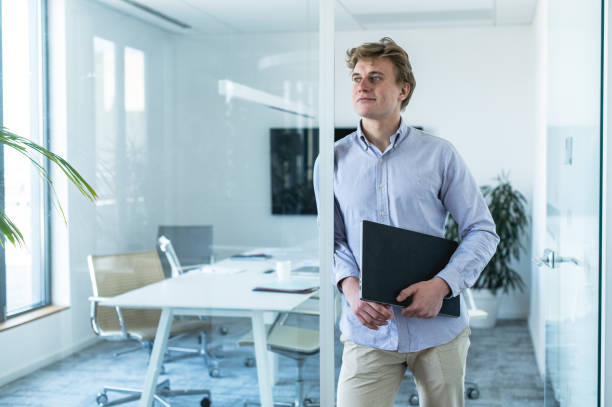 istock Young businessman with papers in the office 1400494522