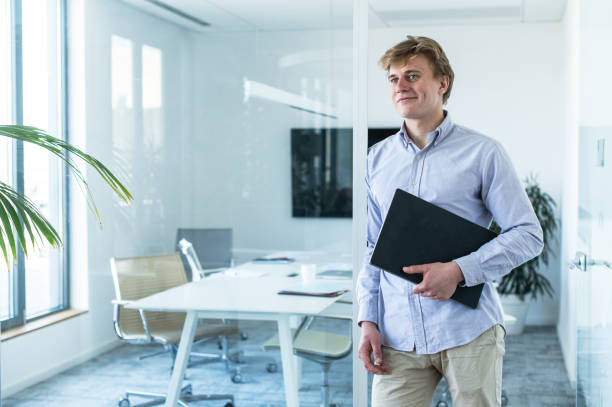 istock Young businessman with papers in the office 1400494564