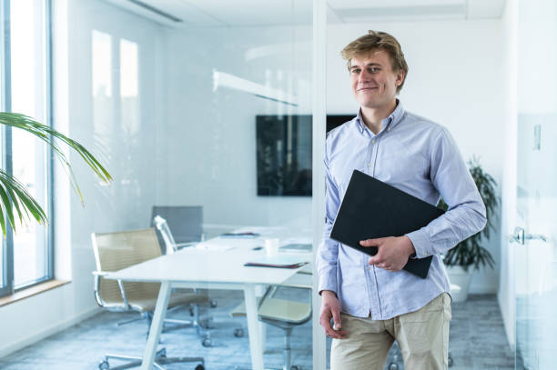 istock Young businessman with papers in the office 1400494565