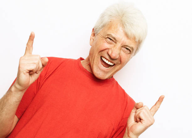 istock Senior handsome man over isolated white background smiling amazed and surprised and pointing up with fingers 1400497704