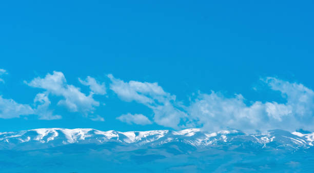 Free Stock Photo of Snowy mountain range under a blue sky with light ...