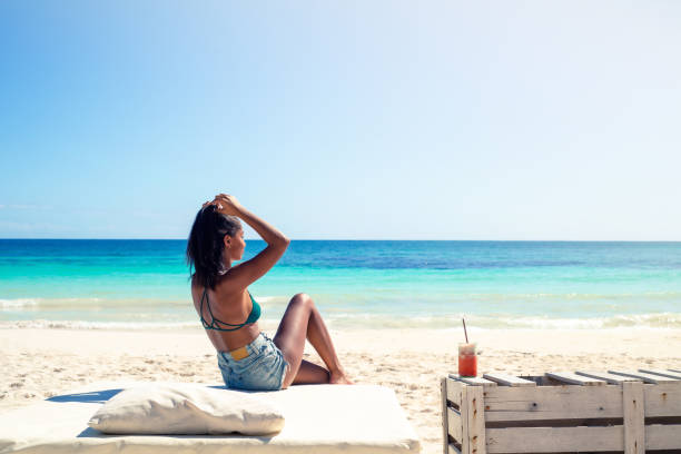 istock Beautiful Young Black Woman Relaxing on the Beach 1400498580