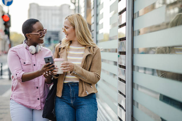 istock Two young confident female friends hanging out and using mobile phone 1400500500