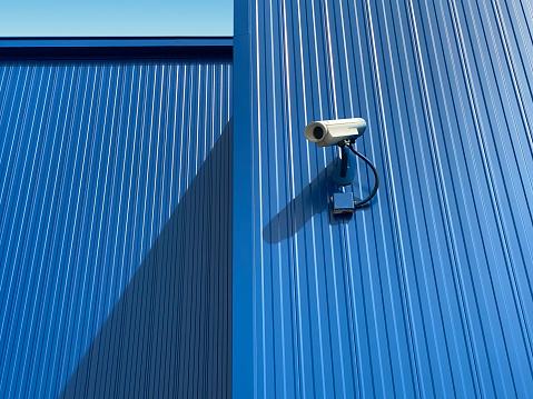 CCTV security camera system being used for surveillance purposes placed on a brick wall with copy space, stock photo image