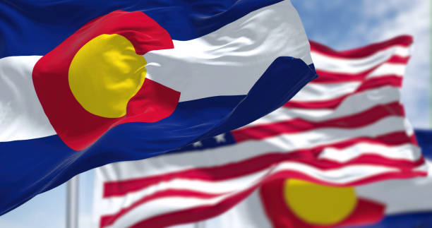 colorado state flags waving along with the national flag of the united states of america - colorado flag imagens e fotografias de stock