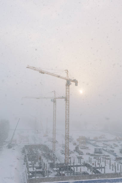 istock building cranes on the construction site during snowfall in winter 1400504006