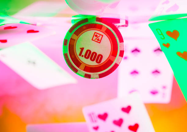 poker chip among flying playing cards on bright colored backgrounds macro with empty space for name, text, inscriptions