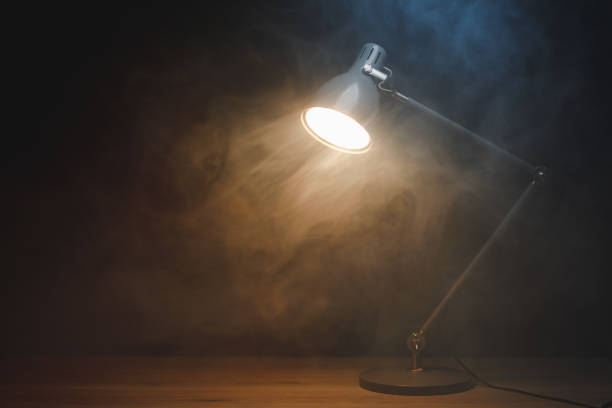 istock desk lamp in smoke, copy-space background 1400504159