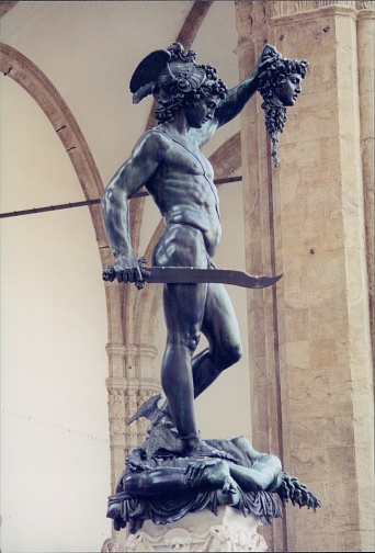Detail of Perseus holding head of Medusa, bronze statue in Loggia de Lanzi, Piazza della Signoria, Florence, Italy. Isolated on white