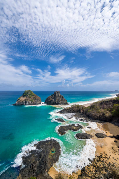 Fernando de Noronha Island, Porcos Bay Beach and Dois Irmaos Hills, Pernambuco, Brazil on December 16, 2021. Fernando de Noronha Island, Porcos Bay Beach and Dois Irmaos Hills, Pernambuco, Brazil on December 16, 2021. bay of pigs invasion stock pictures, royalty-free photos & images