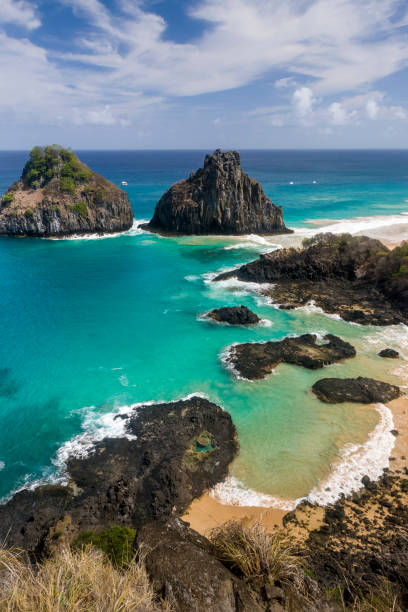 Fernando de Noronha Island, Porcos Bay Beach and Dois Irmaos Hills, Pernambuco, Brazil on December 16, 2021. Fernando de Noronha Island, Porcos Bay Beach and Dois Irmaos Hills, Pernambuco, Brazil on December 16, 2021. bay of pigs invasion stock pictures, royalty-free photos & images