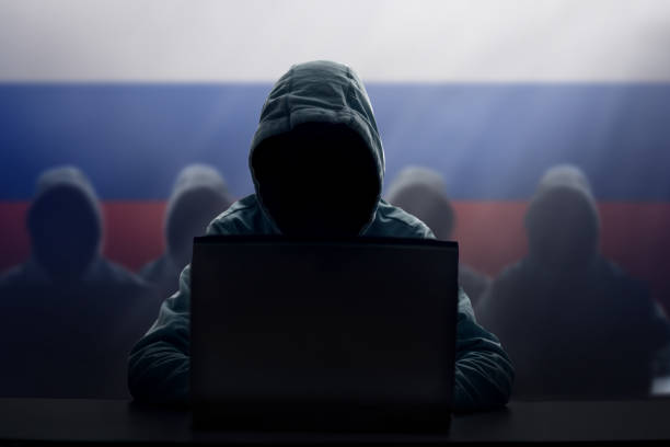 Russian hacker at laptop. Malware and virus. stock photo