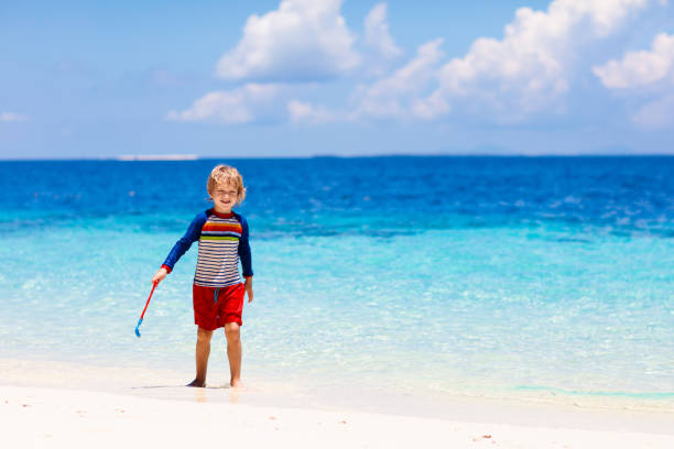 istock Kids playing on beach. Children play at sea. 1400508945