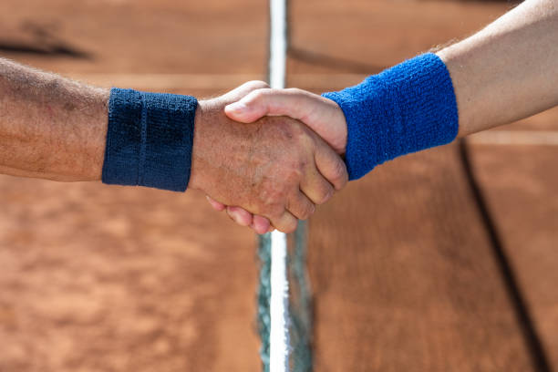 istock Rivals shaking hands on court after match 1400512284