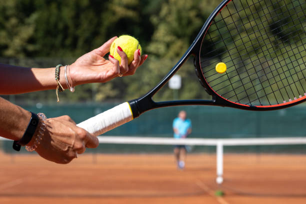 istock Female hands holding tennis ball and racket 1400512300