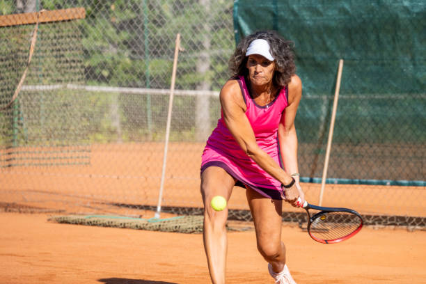 istock Female tennis player concentrating on playing ball 1400512306