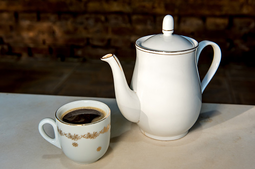 Antique porcelain coffee teapot and cup.