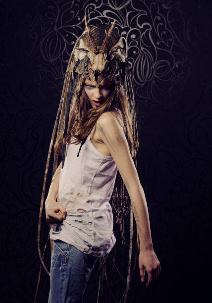 istock Young female model with bright makeup, braids and a skull on her head 1400518134