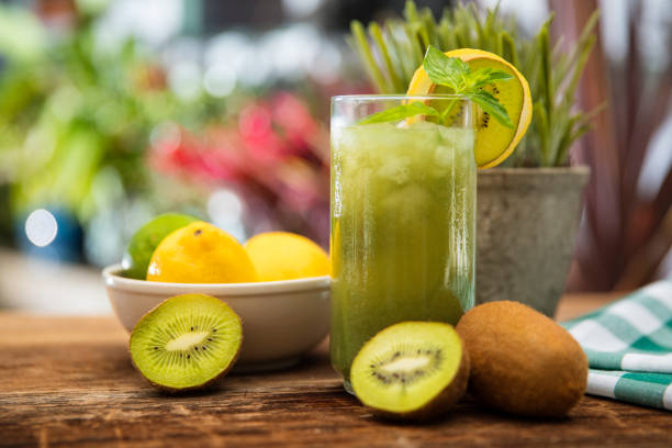 Kiwi and lemon fruit juice drink This is a close-up photograph of a Kiwi Lemon fresh fruit drink for the summer time with mint juice bar stock pictures, royalty-free photos & images