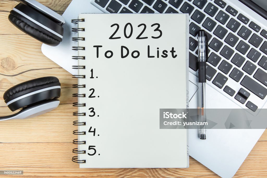 To Do List 2023 To Do List 2023 text on notepad with laptop and a earphone on wooden background New Year Resolution Stock Photo