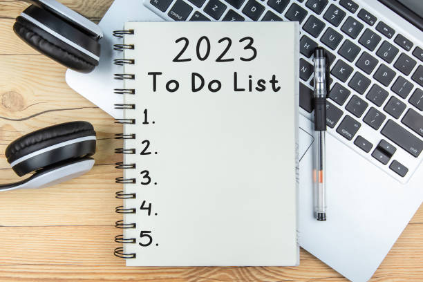 To Do List 2023 To Do List 2023 text on notepad with laptop and a earphone on wooden background new year resolution stock pictures, royalty-free photos & images