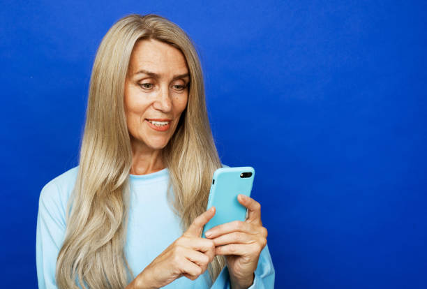 istock elderly woman selfie mobile isolated 1400522563