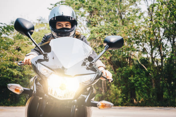 istock Confidence Asian woman wearing a motorcycle helmet before riding. 1400522666