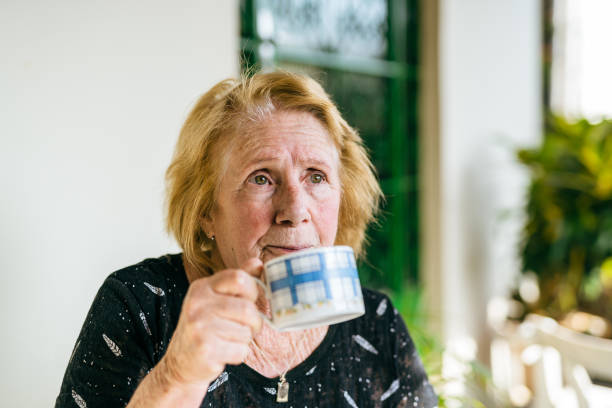 istock Elderly woman holding a cup of tea 1400523341