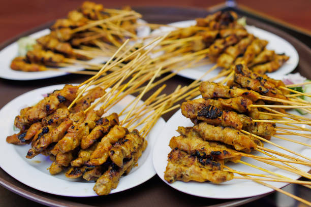 istock Chicken satay with delicious peanut sauce, onion and cucumber. 1400528797