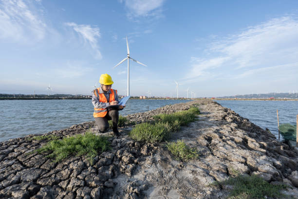 istock A female engineer at a seaside wind farm keeps a log book. 1400529095