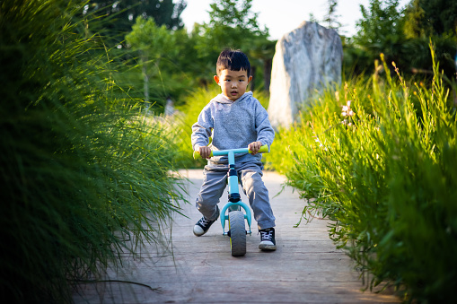 little kid boy driving his bike