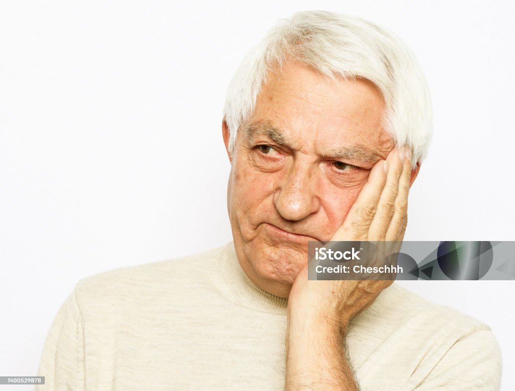 lifestyle, health and old people concept: Portrait of an old man having a toothache against white background lifestyle, health and old people concept: Portrait of an old man having a toothache against white background, close up Canal Stock Photo