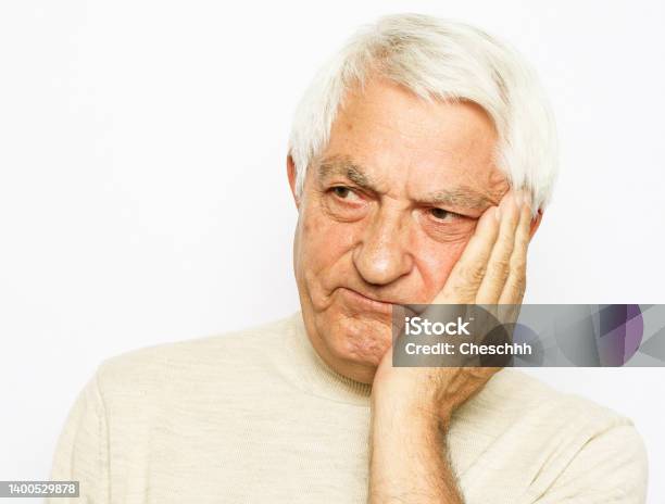 Lifestyle Health And Old People Concept Portrait Of An Old Man Having A Toothache Against White Background Stock Photo - Download Image Now