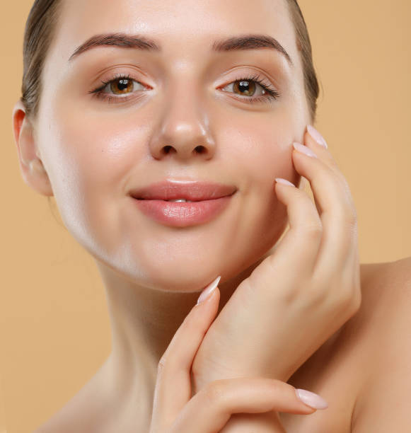 istock Happy beautiful woman holding her cheeks a laugh looking to the side. 1400530865