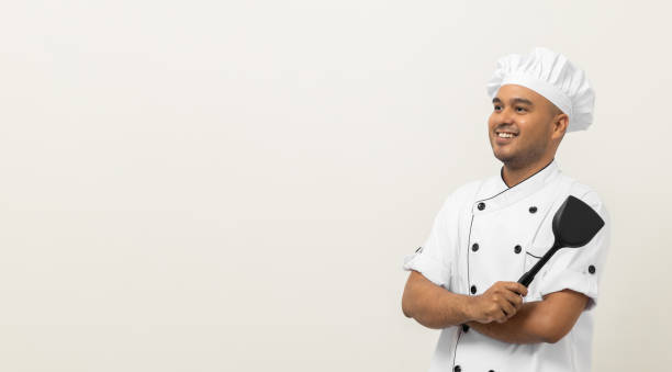 istock Young handsome asian man chef in uniform standing with turner kitchen utensils various gesture action on isolated background. Cooking man Occupation chef People in kitchen restaurant and hotel. 1400533539