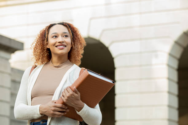 istock Beautiful college student walks on university campus on fall day 1400534340